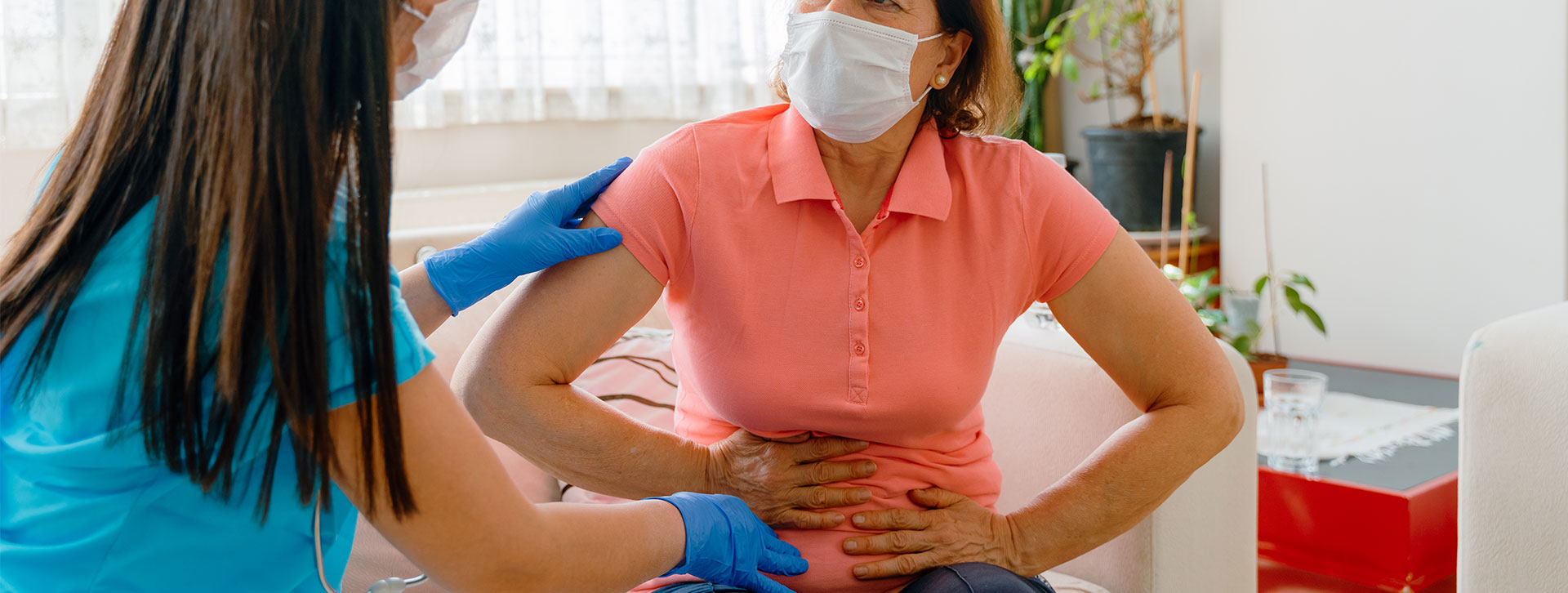 Abdominal pain patient woman having medical exam with doctor.