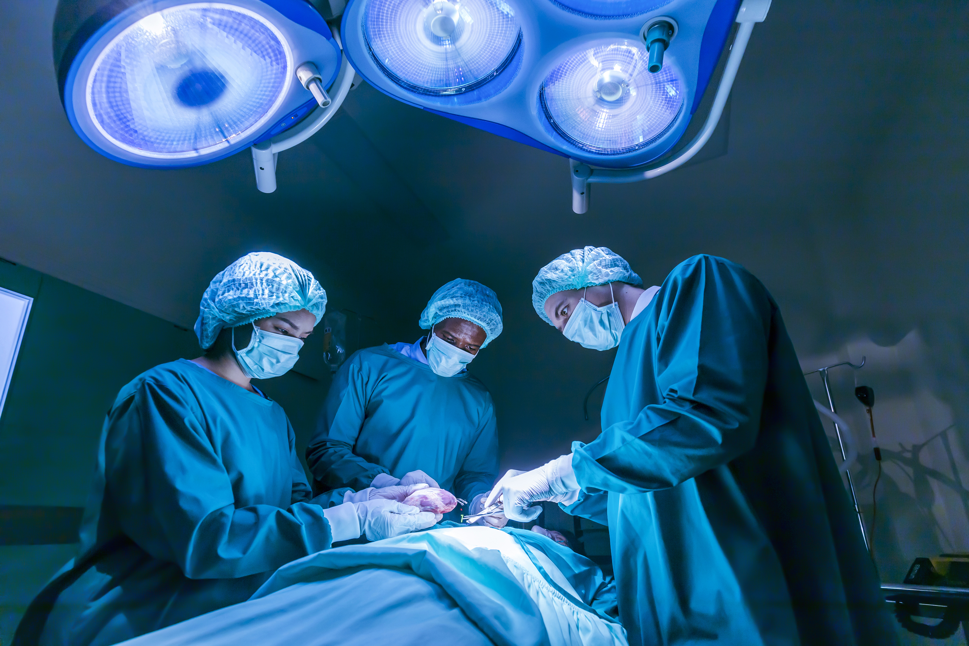 Three doctors doing brain surgery