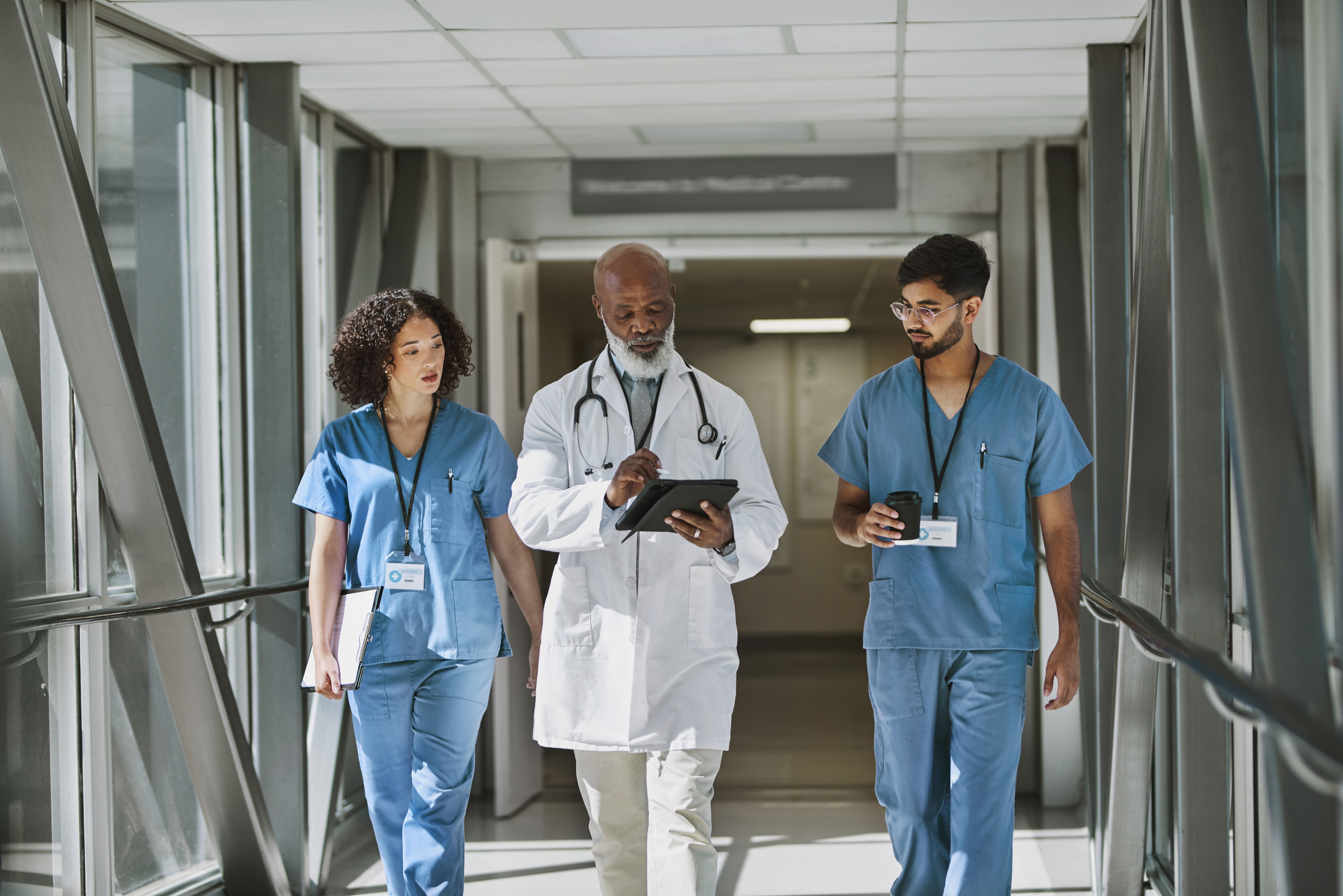 Doctor walking with other doctors.