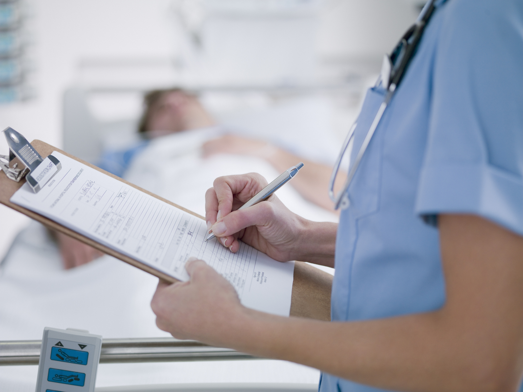 Nurse tending patient in intensive care