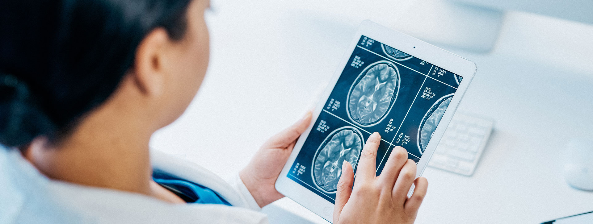 Shot of a young doctor analysing brain scans on a digital tablet.