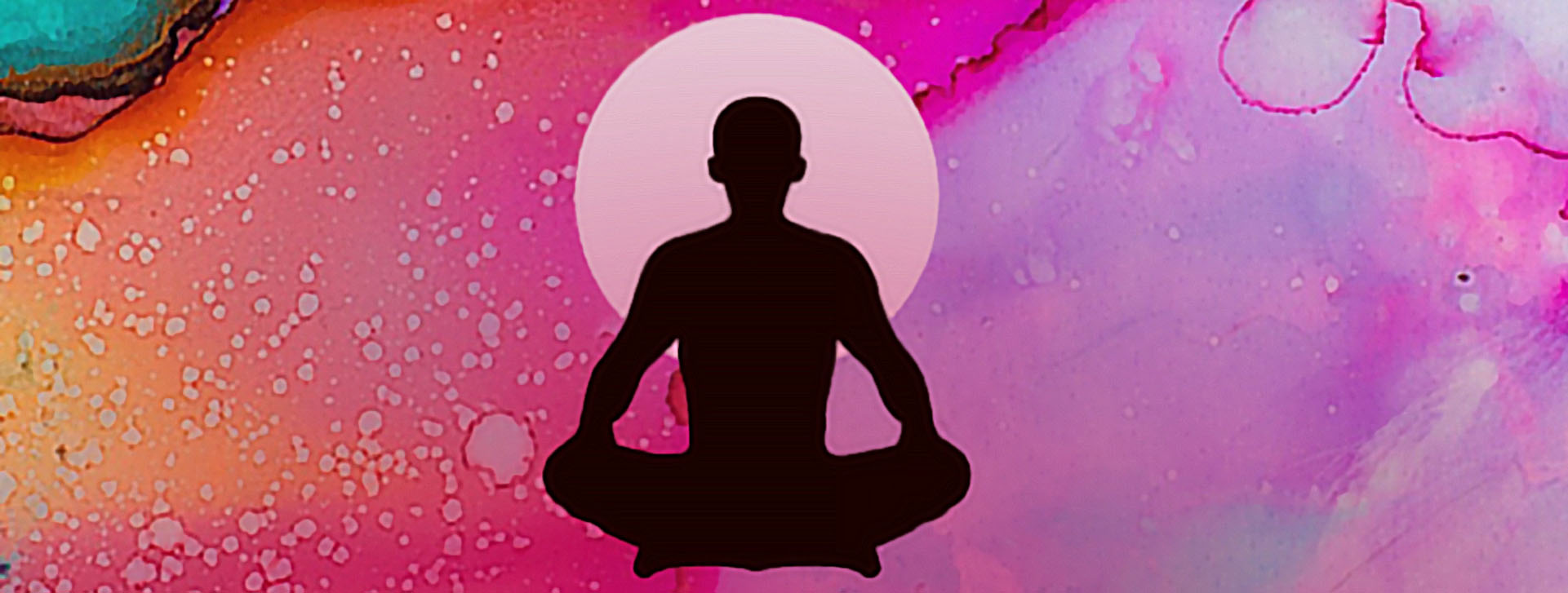 Silhouette of a person sitting in meditation pose in front of a multi colored background.