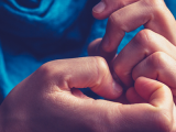 Close up of two hands with fingers touching. 