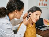 Female doctor performing routine exam on senior patient.