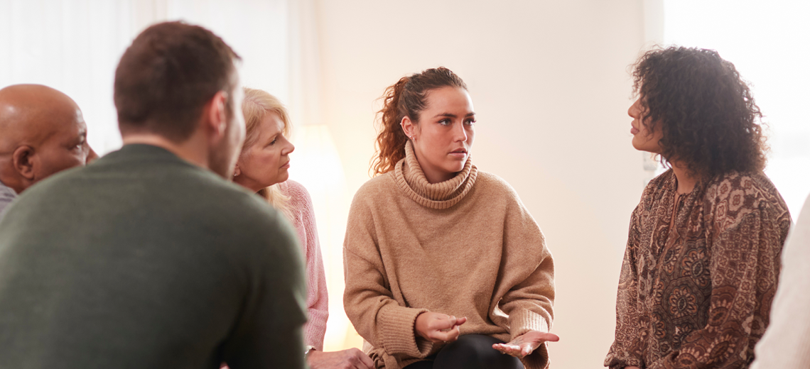 people sitting in therapy circle.