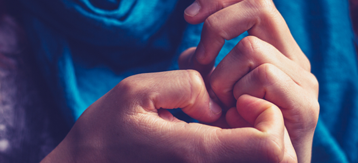 Close up of two hands with fingers touching. 